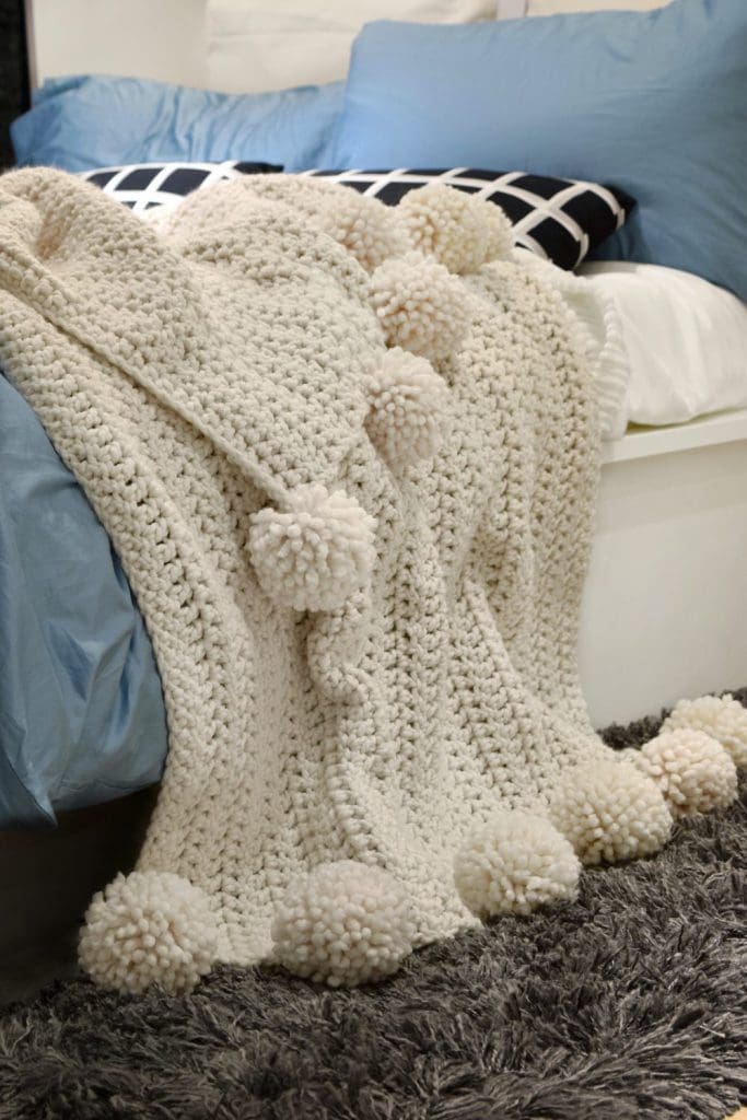 Throw blanket with pom poms