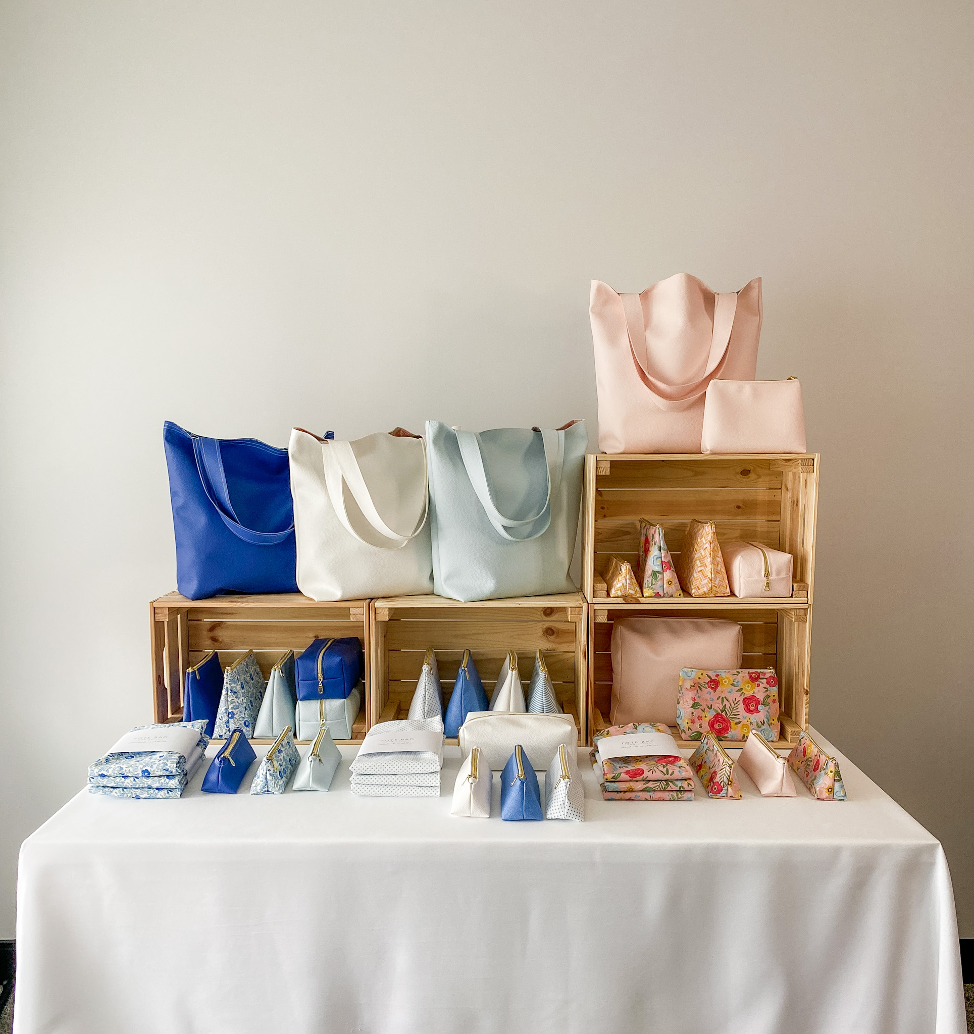 Stuffing tote bags in a craft show display