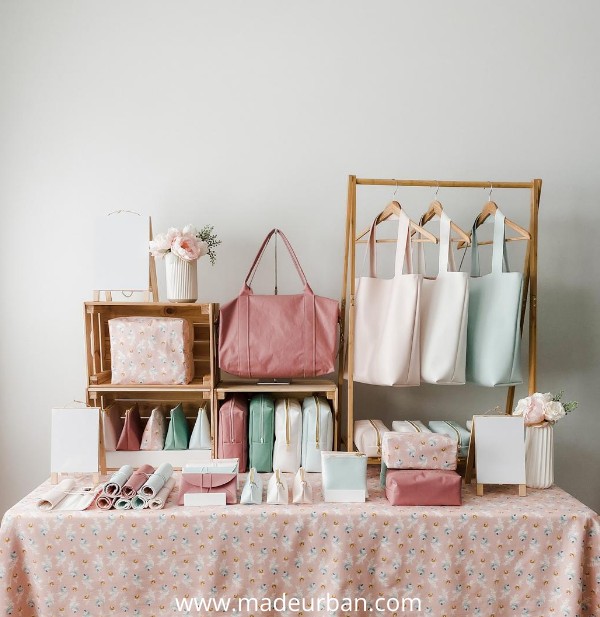 Repeating fabric print in a handbag craft fair display.