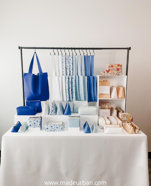 Handbags displayed on a table rod